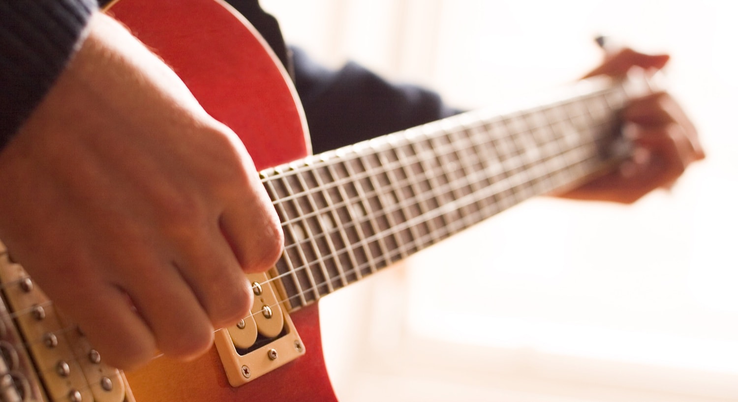 Close up view of a person playing a guitar