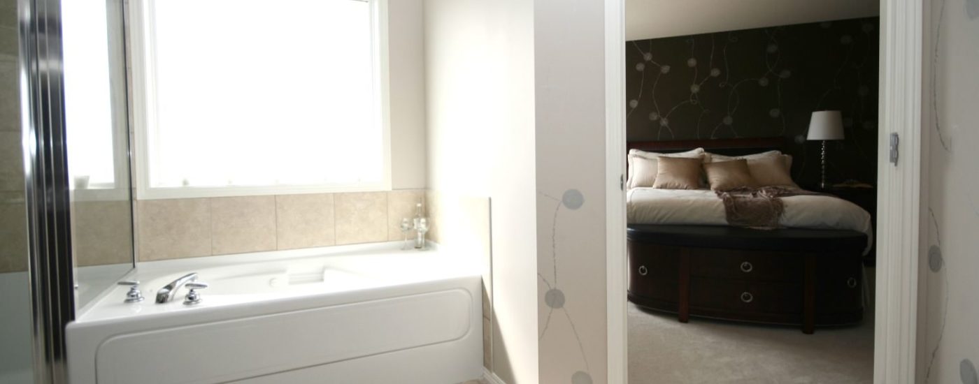 Bathroom with large white tub and separate stand up shower with tiled floor