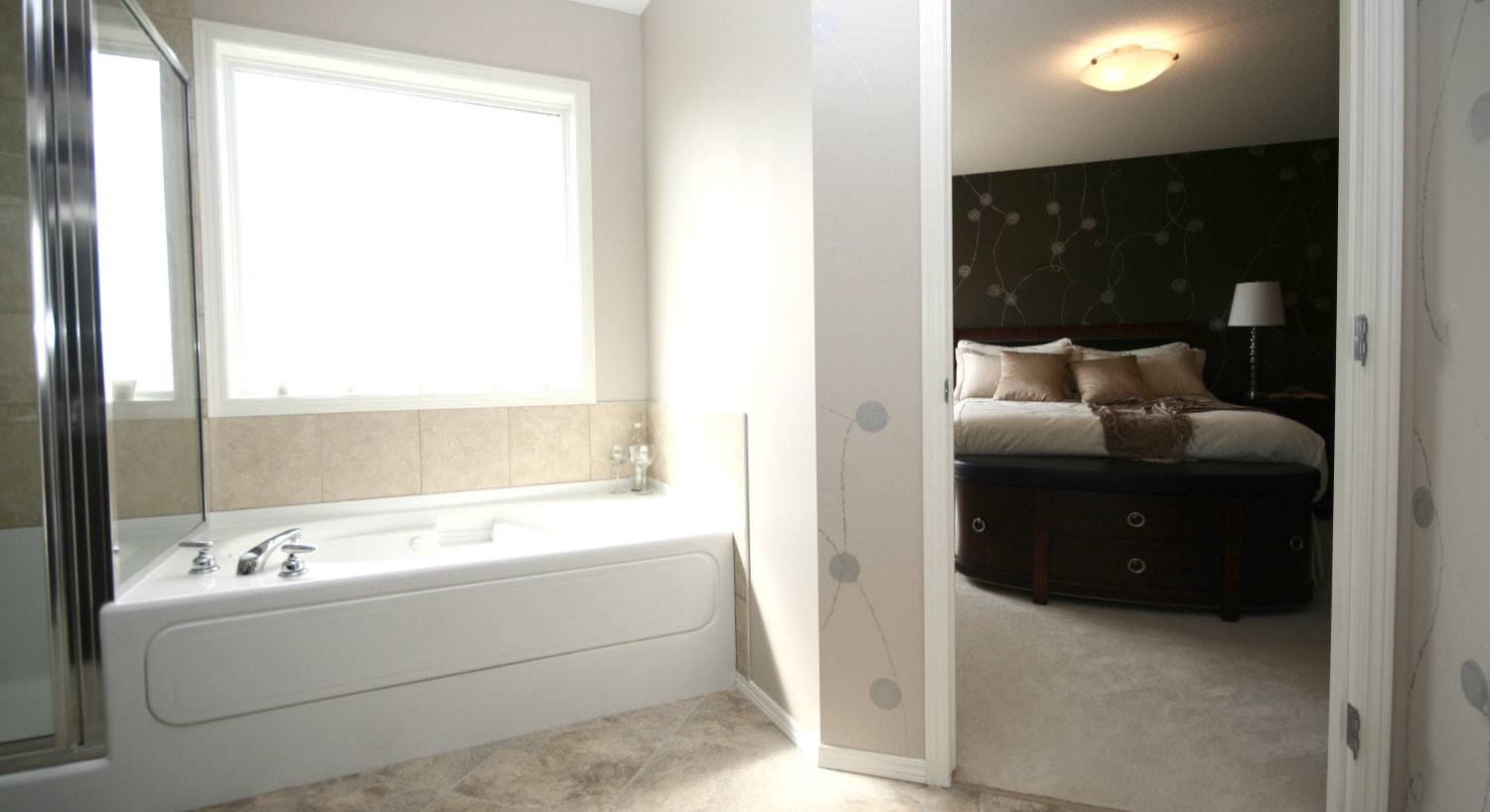 Bathroom with large white tub and separate stand up shower with tiled floor