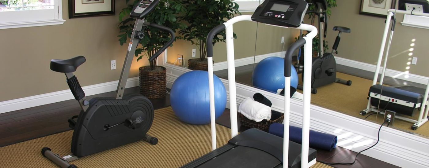 Room with stationary bike and treadmill