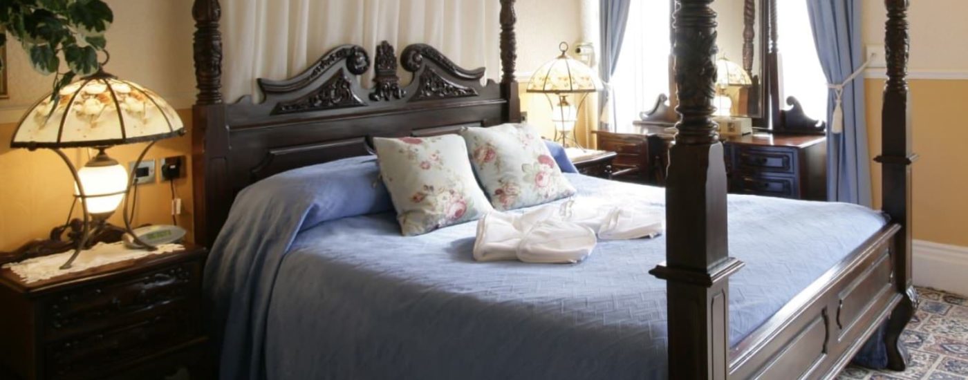 Bedroom with dark wooden bed and furniture