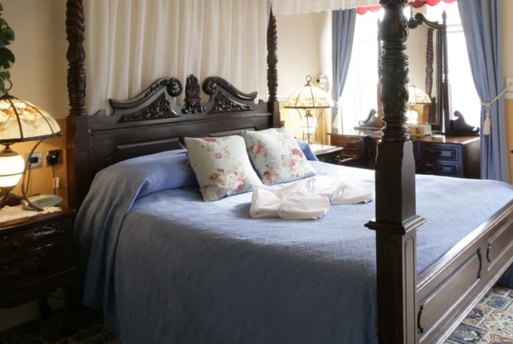 Bedroom with dark wooden bed and furniture