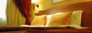 Close up view of pillows on bed leaning against headboard