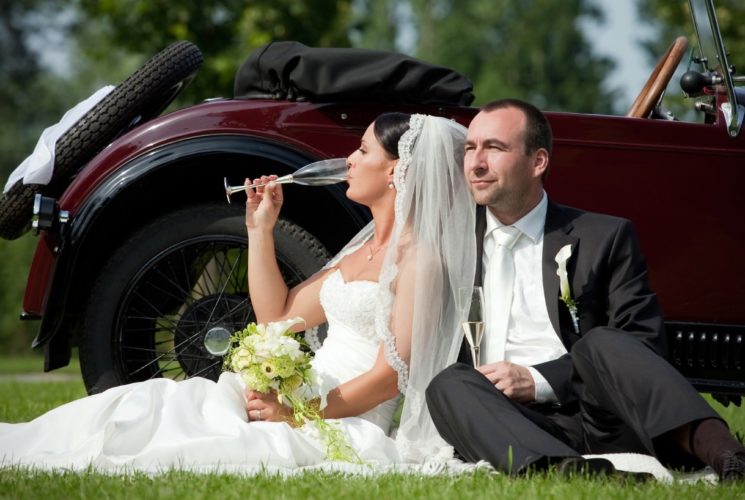 Bride and groom drinking champagne