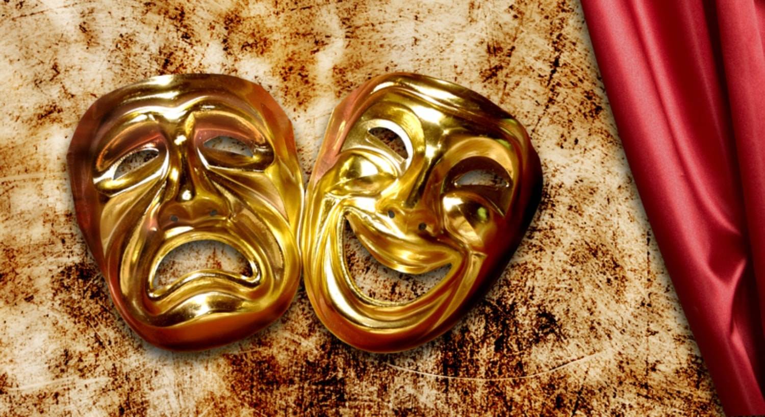 Gold theater masks, one happy, one sad